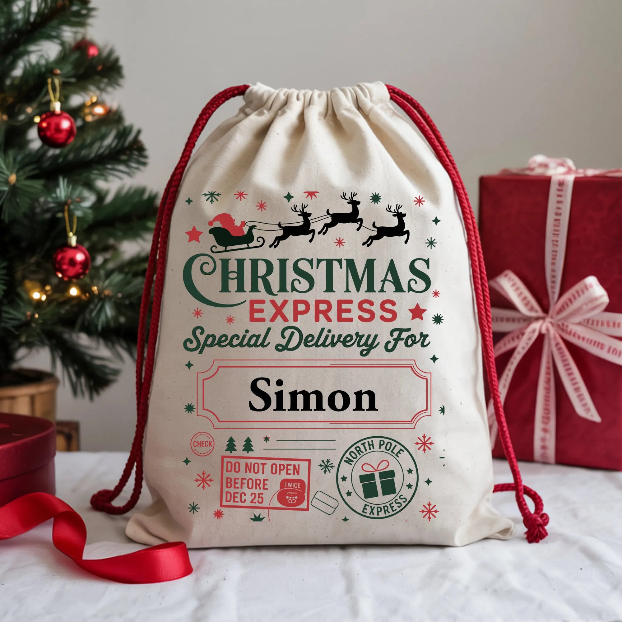 Personalized Christmas gift bag with festive design and text, placed on a table with a Christmas tree and gift box in the background.
