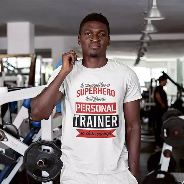 Personalised cotton T-shirt printed with the “I May Not Be a Superhero But I'm a Personal Trainer So Close Enough” slogan and custom name underneath.