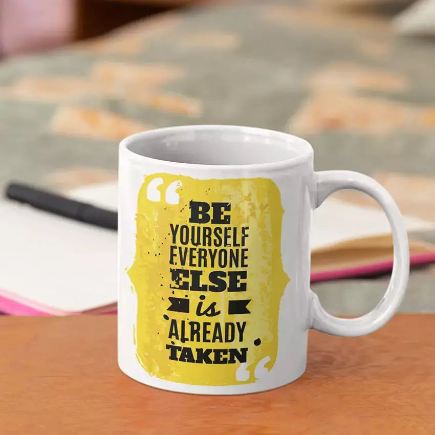 Personalised ceramic mug featuring the Be Yourself Everyone Else Is Already Taken quote with a custom name or message available on the reverse.
