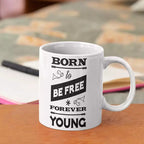 Born to Be Free Forever Young ceramic mug with black interior and quote design.