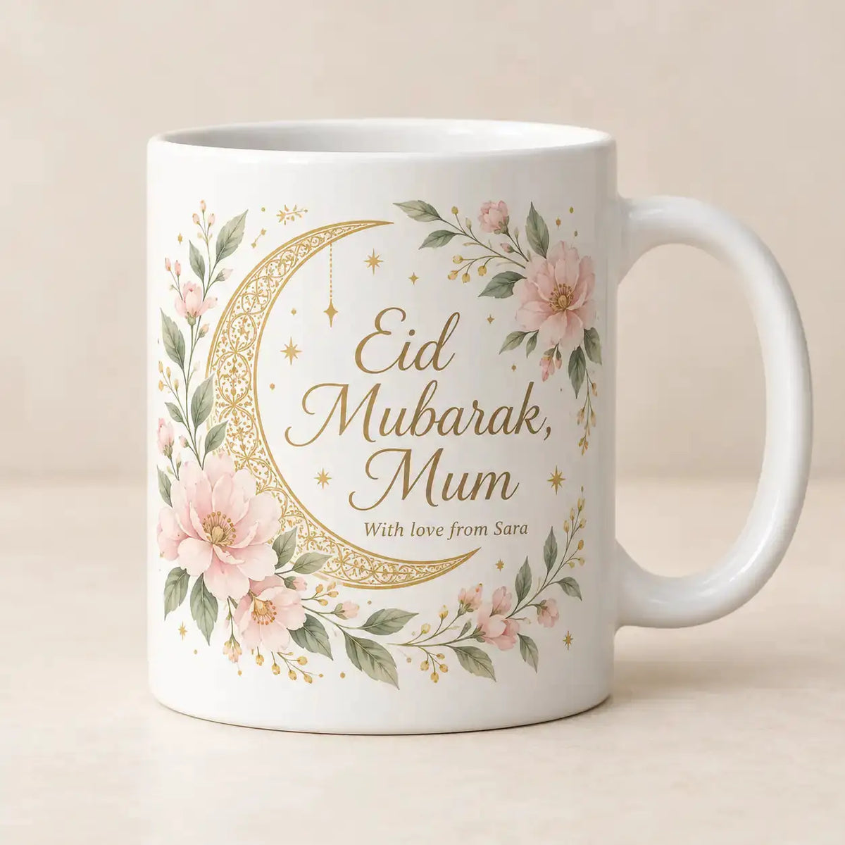 Personalised Eid Mubarak Mum mug with pink floral crescent moon design, gold lettering and custom With love from Sara message on a white ceramic mug.