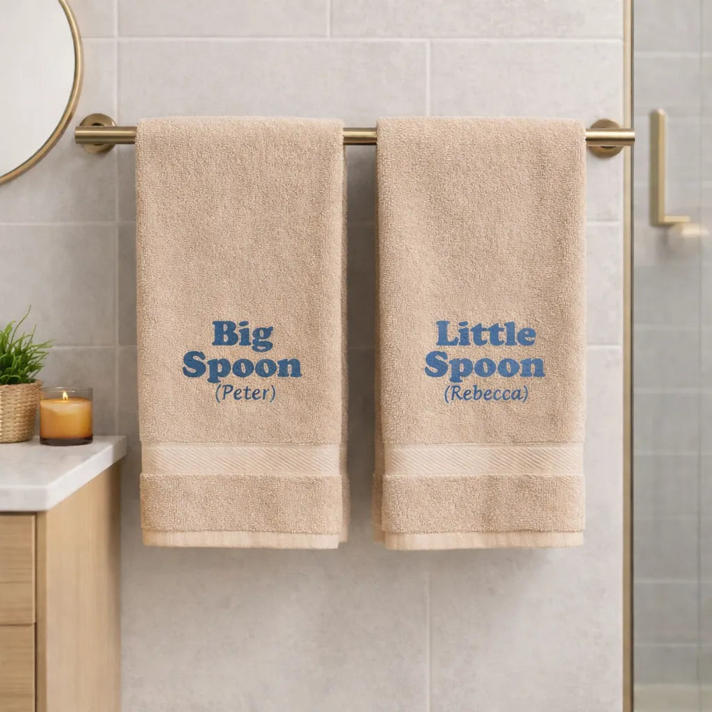 Beige personalised Big Spoon and Little Spoon towels with embroidered names hanging in bathroom