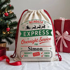 Personalised Reindeer Express Christmas sack with custom name, festive red and green artwork, reindeer silhouettes and North Pole overnight delivery design.