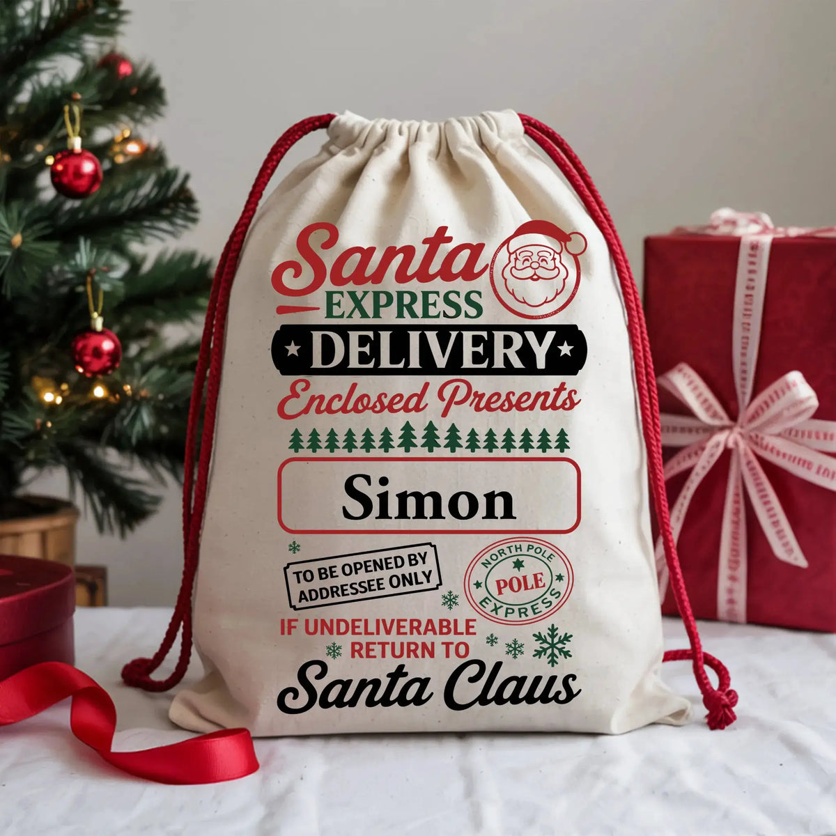 Personalised Santa Express Christmas sack with custom name, vintage North Pole delivery artwork, festive red and green print and cotton drawstring closure.