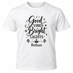 White personalised Diwali Good Vibes Bright Lights T-shirt with black lettering, diya, hanging lanterns, fireworks and custom name Rohan.