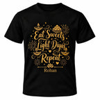 Black personalised Diwali T-shirt with gold Eat Sweets Light Diyas Repeat design, decorative oil lamps, fireworks and custom name.