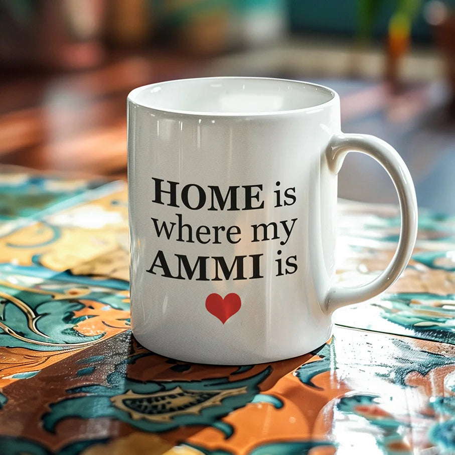 Personalised white ceramic mug with “Home is where my Ammi is” text and red heart design, custom family love mug gift, emotional printed mug displayed on decorative table