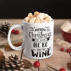 Funny personalised Christmas mug with Merry Christmas I'm Just Here for the Wine slogan on a white ceramic mug.