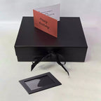 Black photo frame inside luxury pamper hamper gift box displaying personalised photo insert with prosecco chocolate and candle gift set