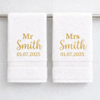 White luxury cotton Mr and Mrs towels with gold embroidered surname and wedding date in bathroom