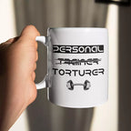 Personalised ceramic mug displaying the “Personal (Trainer) Torturer” joke on the front, with optional custom name or message printed on the reverse.