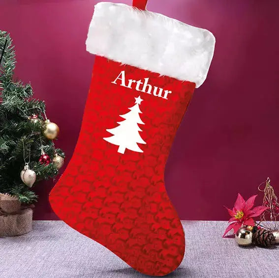 Personalised red velvet Christmas stocking with fluffy white trim, Christmas tree motif, custom printed name and hanging loop.