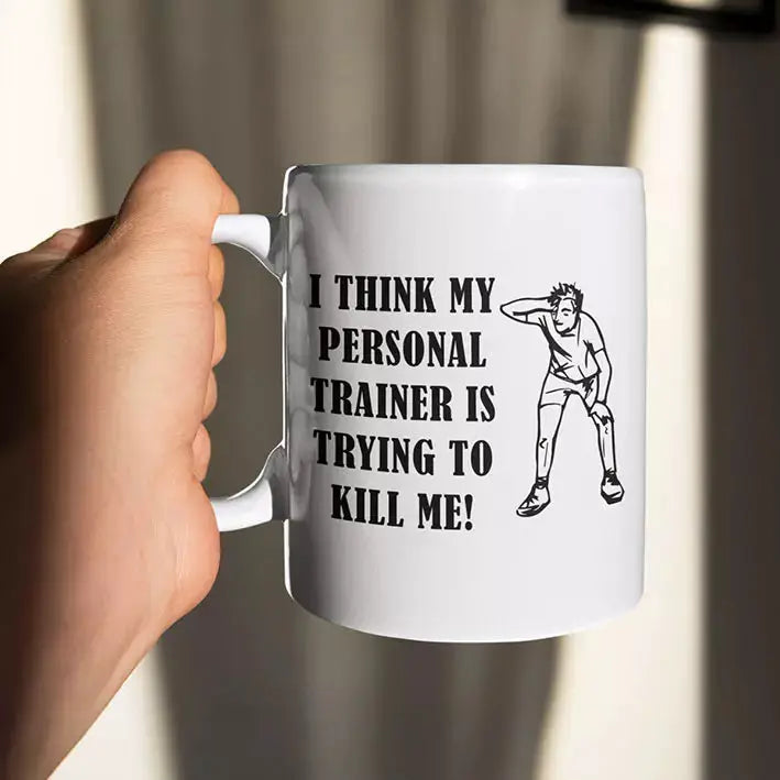 Personalised funny gym mug featuring I Think My Personal Trainer Is Trying to Kill Me quote