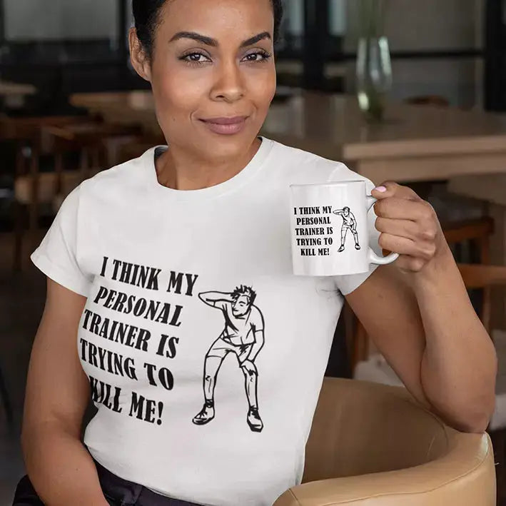 Personalised funny gym T-shirt featuring I Think My Personal Trainer Is Trying to Kill Me slogan