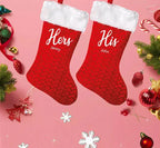 Matching personalised His and Hers red velvet Christmas stockings with fluffy white trim, custom printed wording and hanging loops.