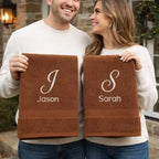 Couple holding personalised embroidered towels with names – luxury gift for couples