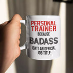 White personalised ceramic mug featuring the funny “Personal Trainer Because Badass Isn't an Official Job Title” quote, with optional name or message on reverse.