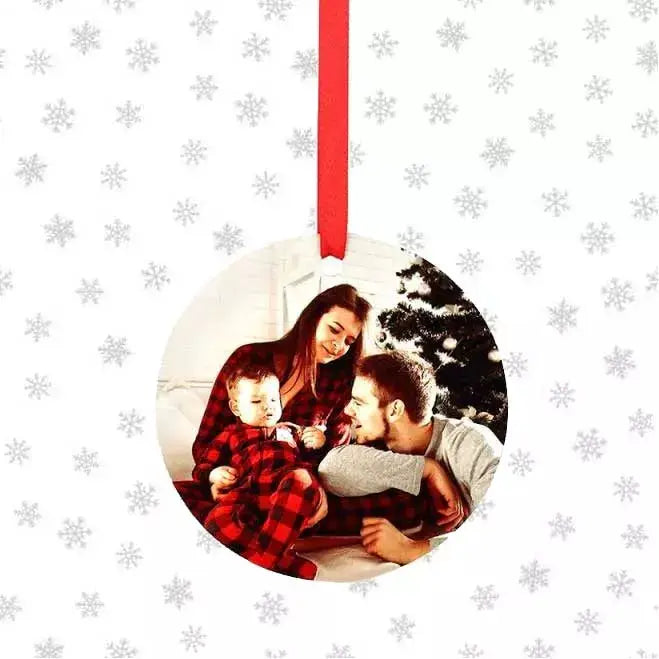 Personalised round photo Christmas bauble featuring a custom photograph on a glossy aluminium tree decoration with hanging ribbon.