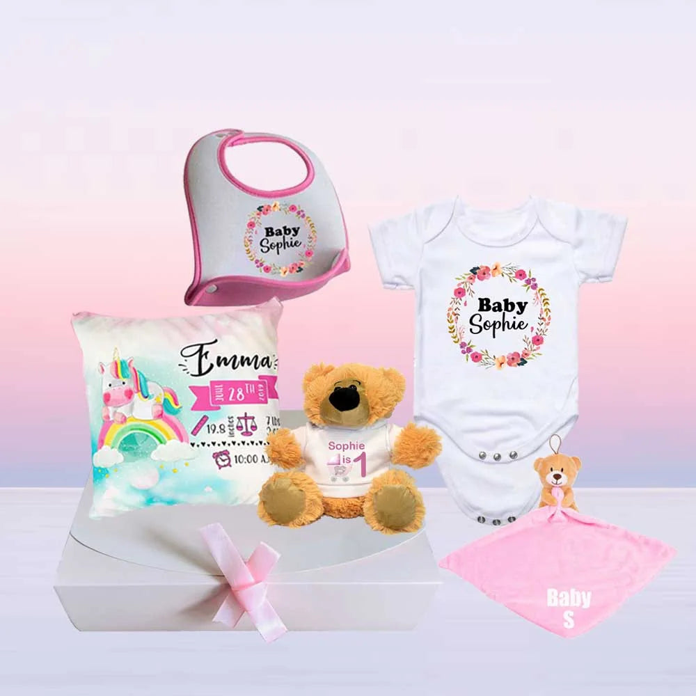 cute baby hamper with babygrow, comforter, teddy bear, baby cushion and bib in a pink presentation box 