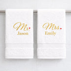White luxury cotton Mr and Mrs towels with gold embroidered names hanging in bathroom