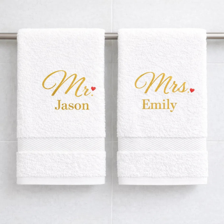 White luxury cotton Mr and Mrs towels with gold embroidered names hanging in bathroom